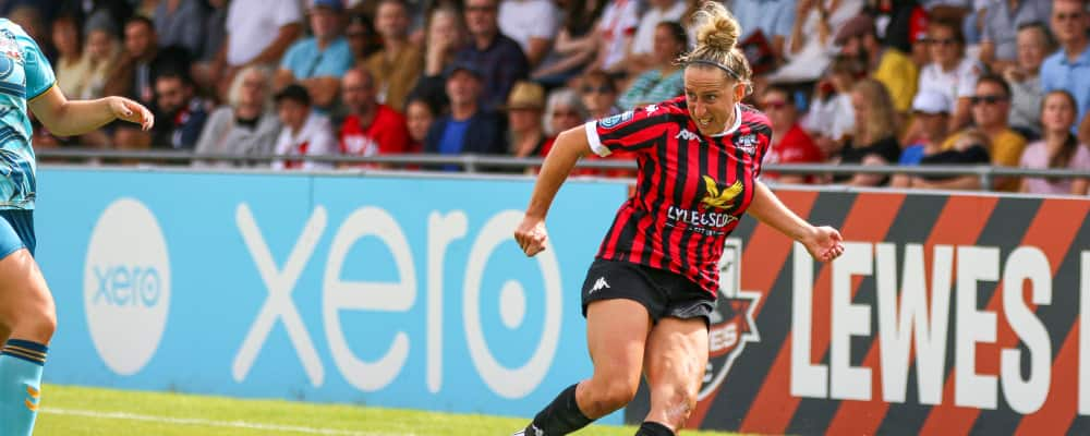 Lewes FC football player runs across pitch